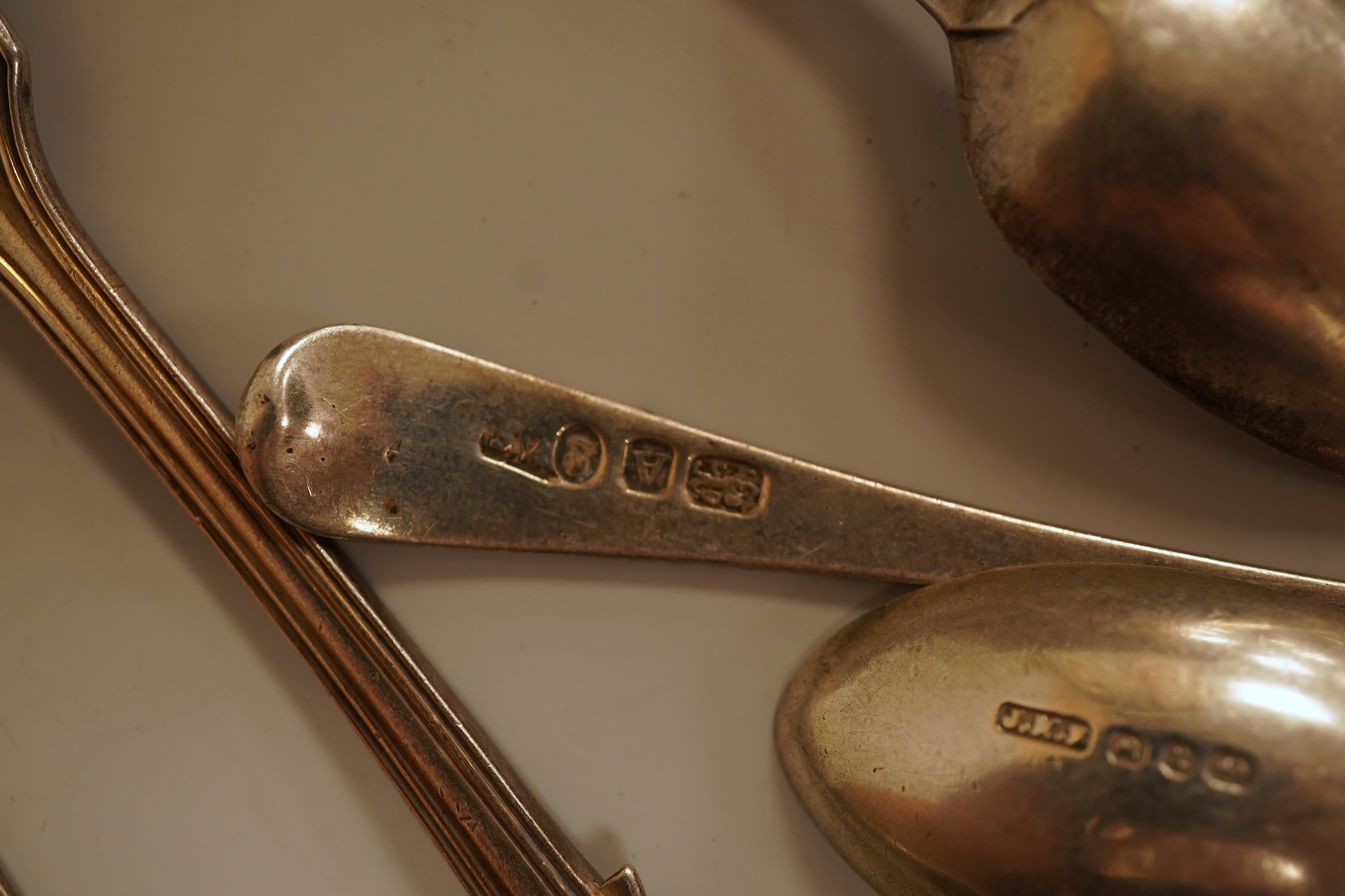 A small quantity of 18th century and later assorted silver teaspoons, various patterns, dates and makers, together with a George V silver pastry fork and two George V silver caddy spoons, 10.7oz.